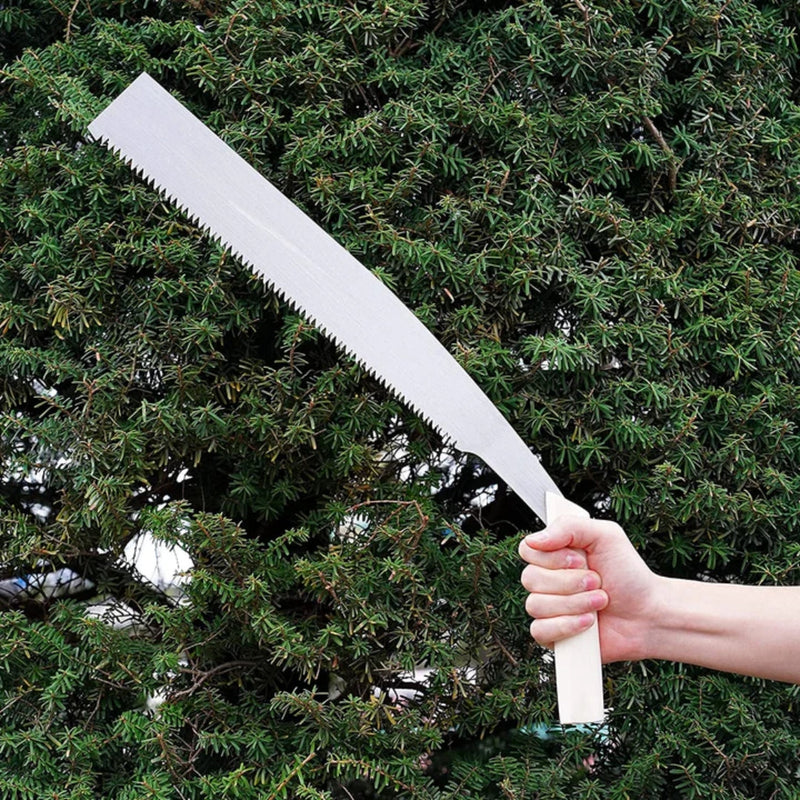 Kakuri Temagari Large Hand Pruning Saw with wooden handle and metal blade with crosscut teeth being held up bu one hand to show the size in front of a tree
